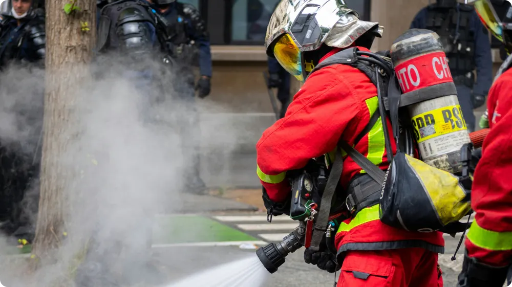 Fire warden using a fire extinguisher in an office environment