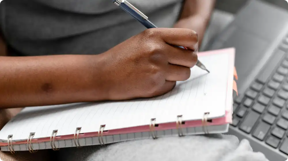 Close-up of an accident report being filled out in a workplace accident book, showing details like date, injury type, and witness information