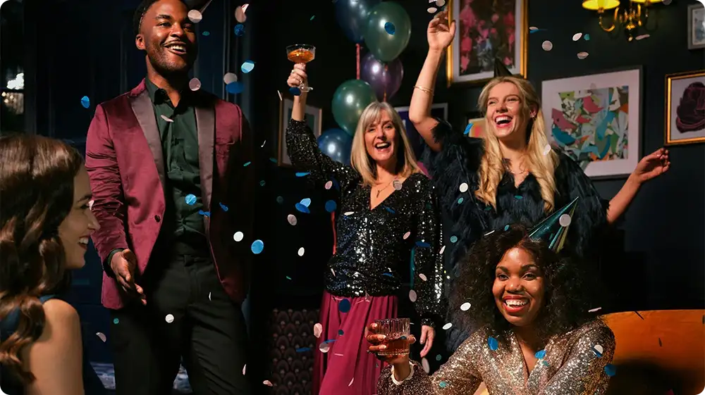 Group of friends enjoying the best night out in the UK with drinks, music, and vibrant party vibes