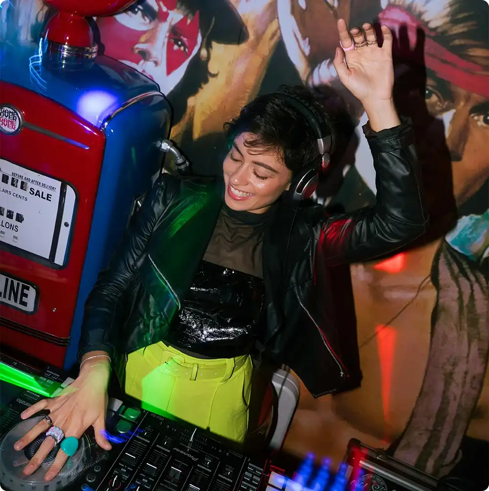 Female DJ spinning at a club showcasing the best nightlife in the UK with energy and music