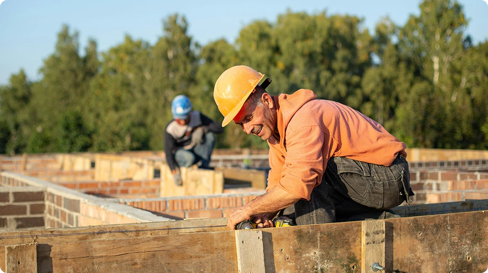 Bricklayer wearing safety gear working on a construction site