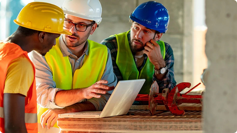 Construction workers talking, representing networking on construction sites.