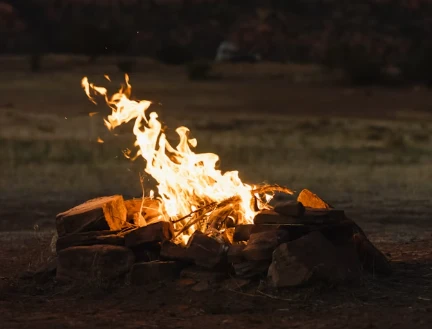 Campfire burning in a stone fire pit, representing fear of fire (pyrophobia)