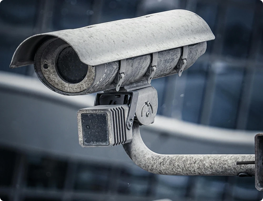 Close-up of surveillance camera in an urban setting part of the history and development of CCTV