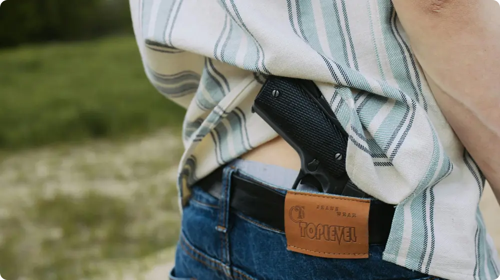 Suspected gang member carrying handgun illegally in UK rural area, highlighting the rise in gun crime UK and illegal firearm possession.
