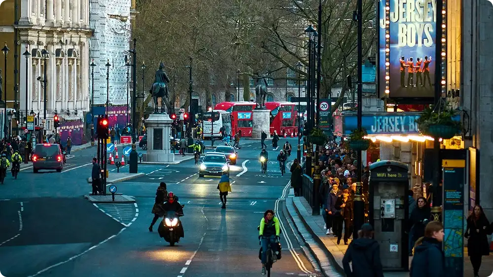 London road with traffic monitoring cameras and CCTV surveillance in a busy urban street.