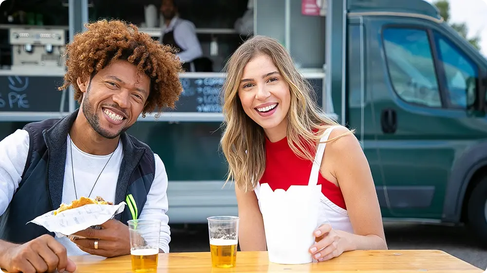Friends enjoying drinks at a mobile bar van
