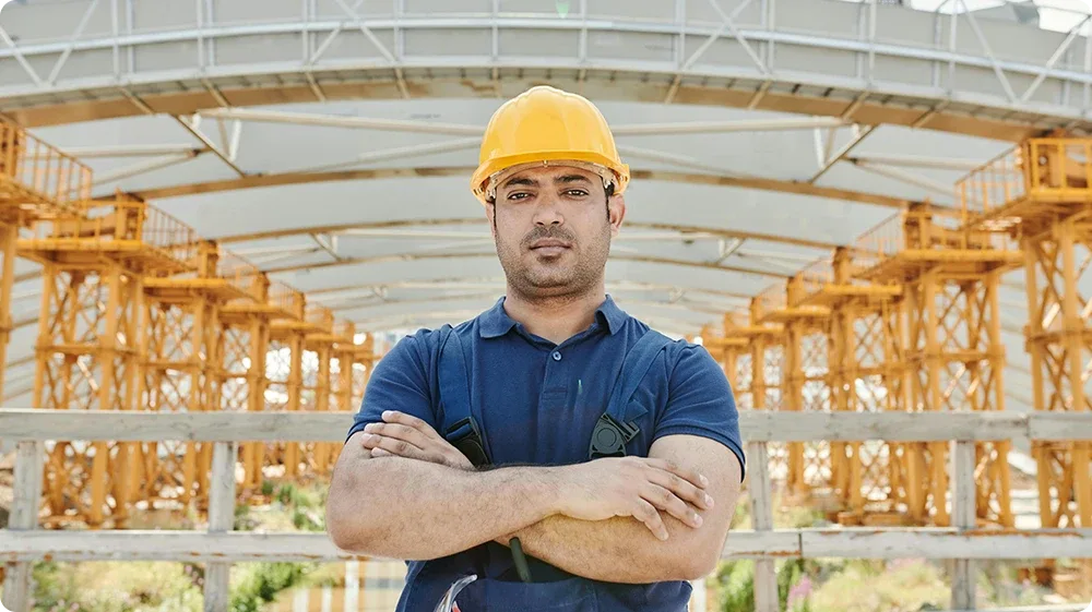 A site manager in a hard hat on a construction site, NVQ Level 6 Construction Site Management