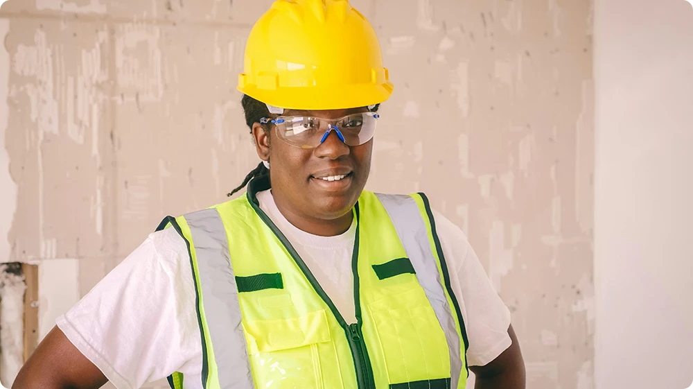 Female construction site manager in hard hat representing NVQ Level 6 construction site management qualification