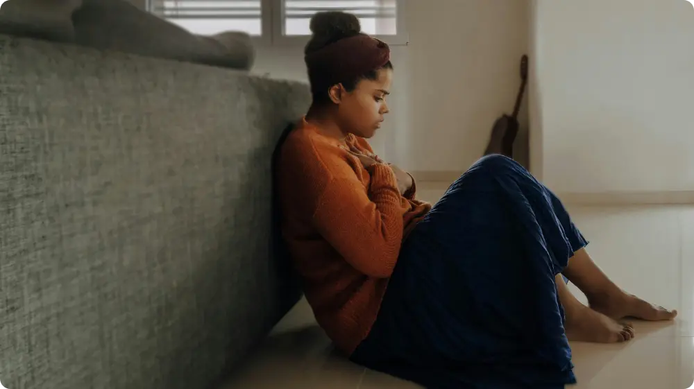 Woman sitting on the floor catastrophising everything