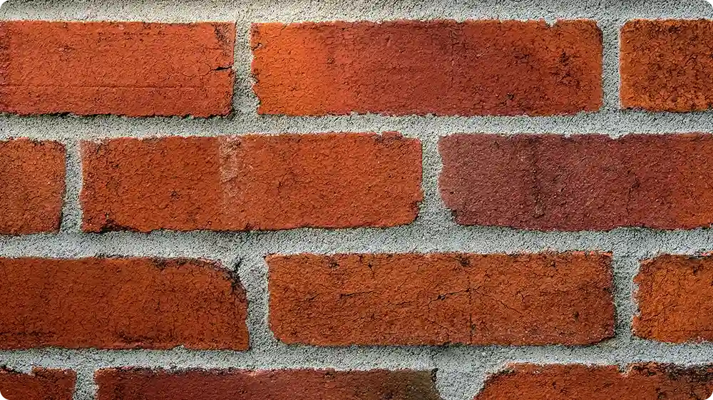 Close-up of repointed brick wall with clean mortar joints
