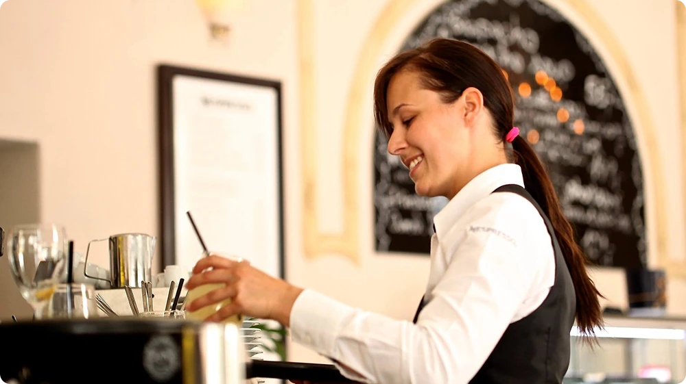 Waitress complying with UK liquor licensing rules for restaurants