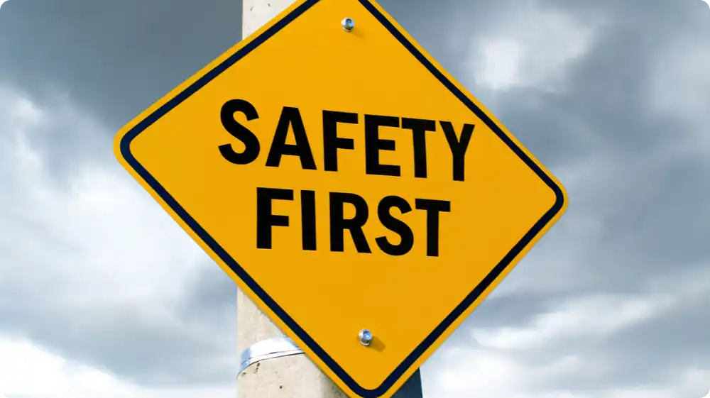 Yellow and black Safety First sign symbolising workplace safety and compliance with health regulations.