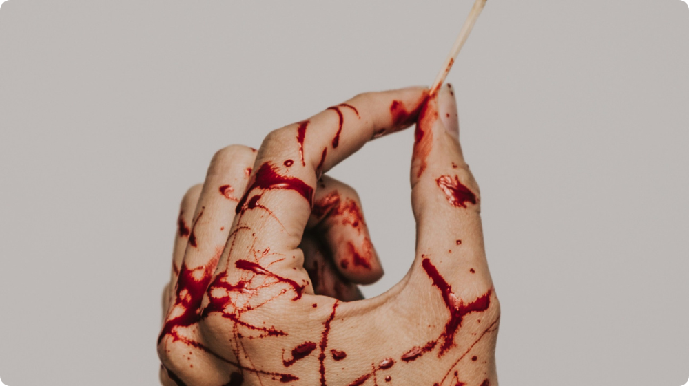  A hand covered in blood symbolising the physical pain associated with self-harm