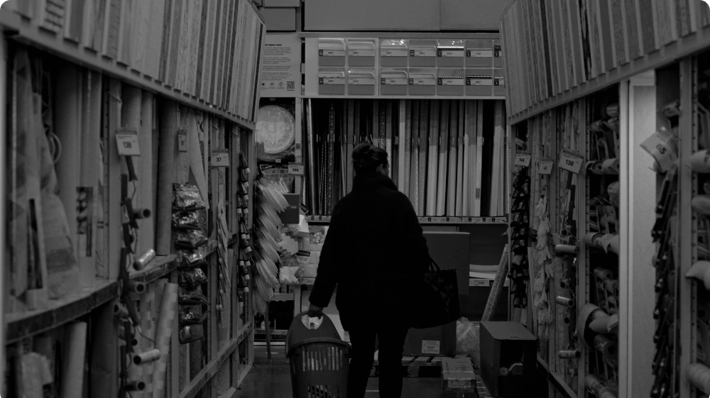 Shopper walking alone in a retail aisle  representing suspicious behaviour patterns linked to shoplifting in UK stores