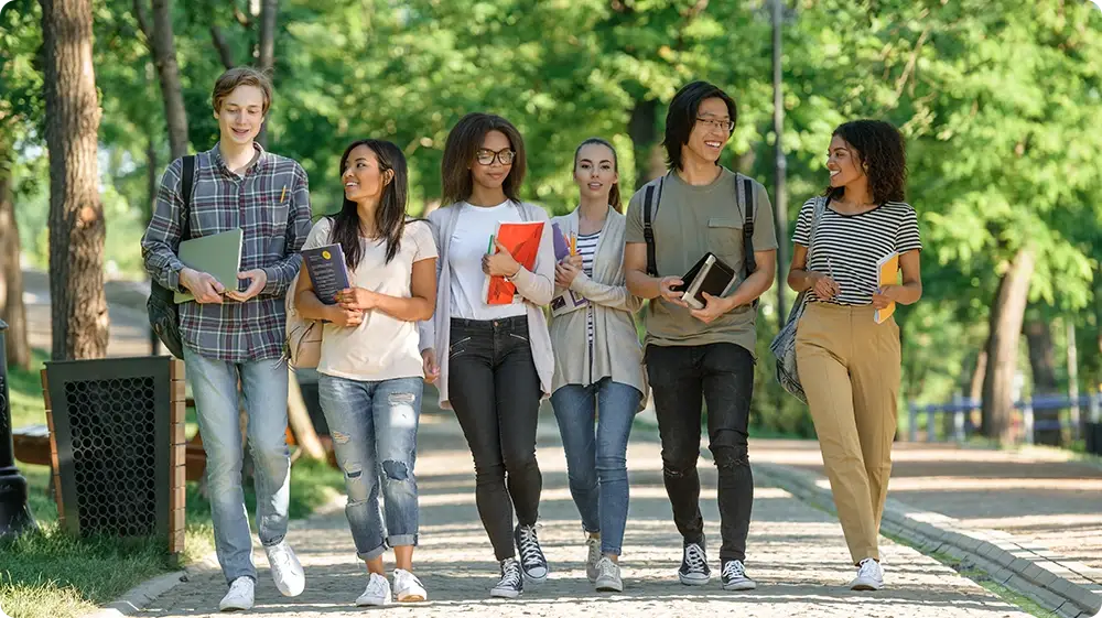 Diverse students walking outside a school, showcasing inclusion and equality in education.