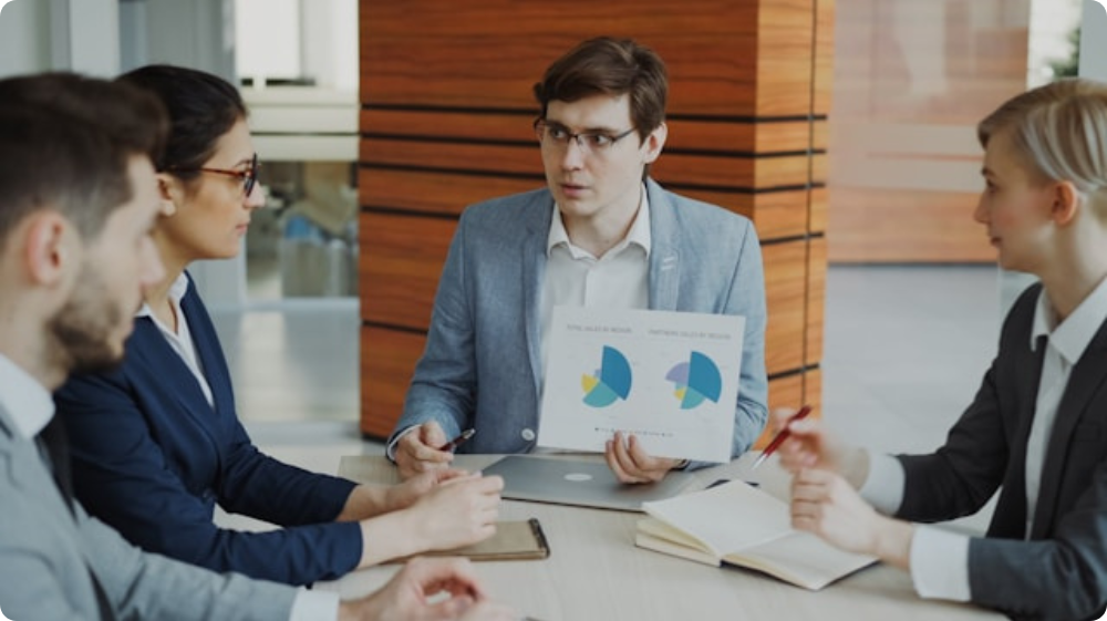 Team reviewing charts and reports during the tender process