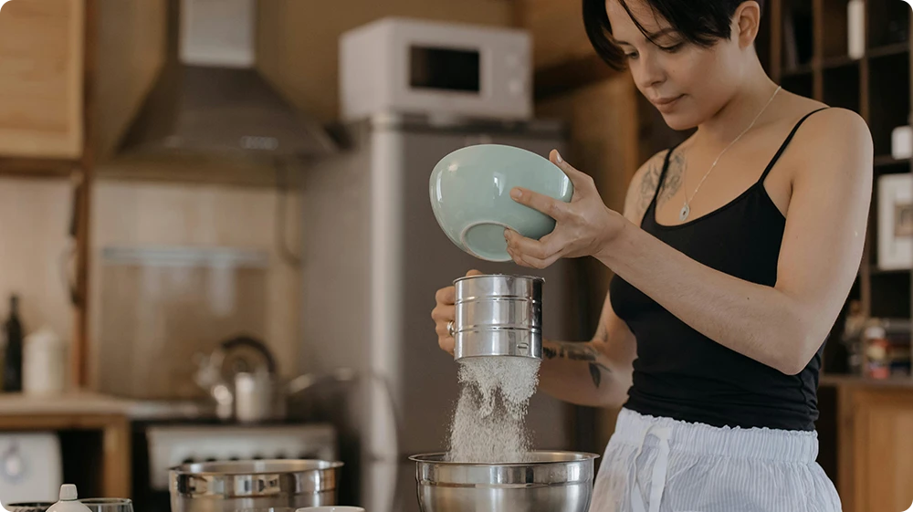 A woman baking at home an example of how to start a food business from home in the UK