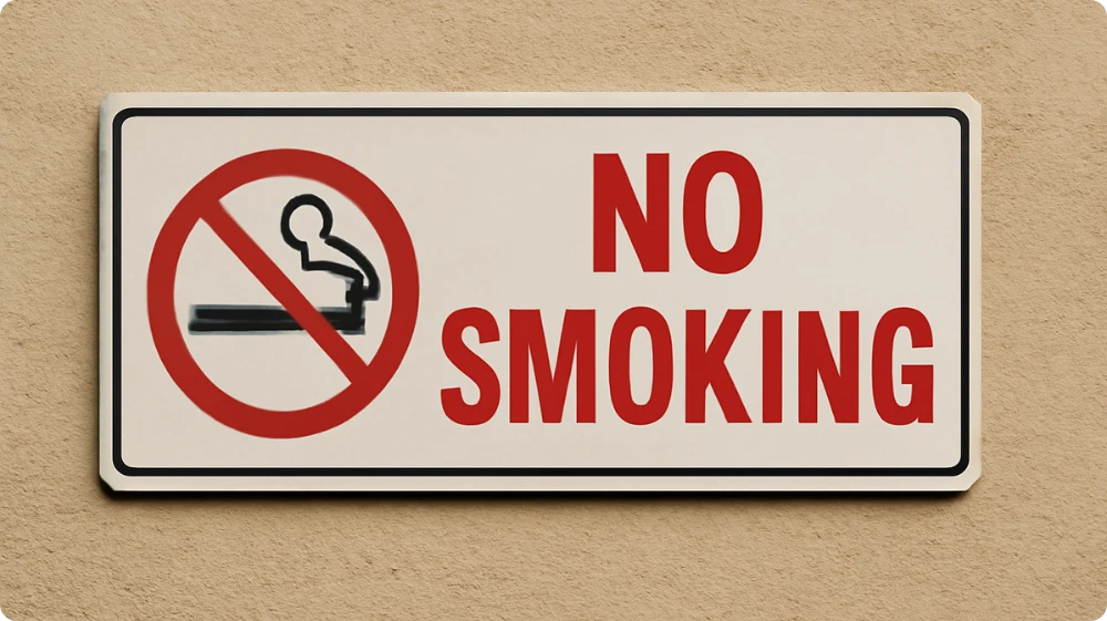 No Smoking sign with a red border and a crossed-out cigarette symbol on a beige background.