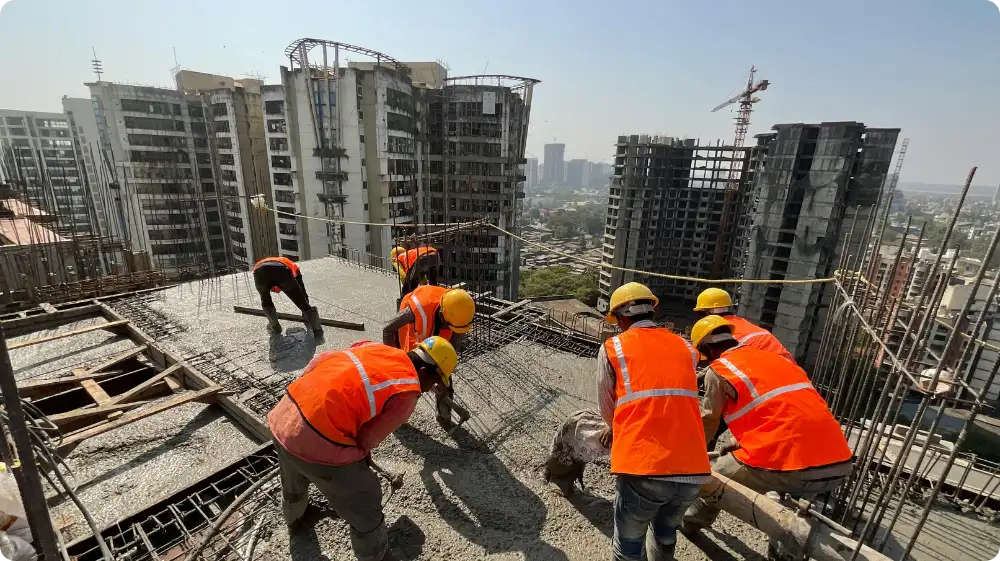 Group of construction professionals in high-visibility jackets and hard hats