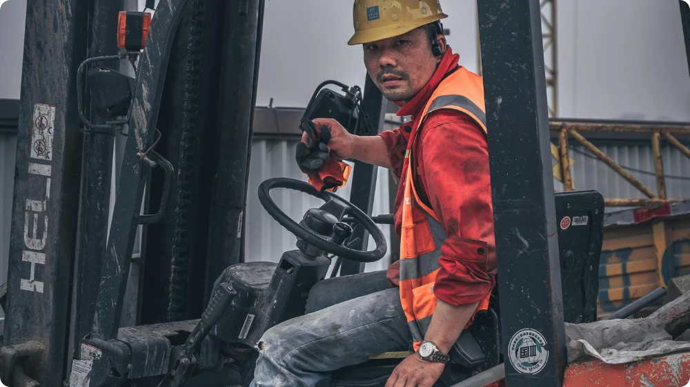  Plant operator holding a CPCS or NPORS card driving a forklift File Name: cpcs-npors-plant-operator-driving-forklift 