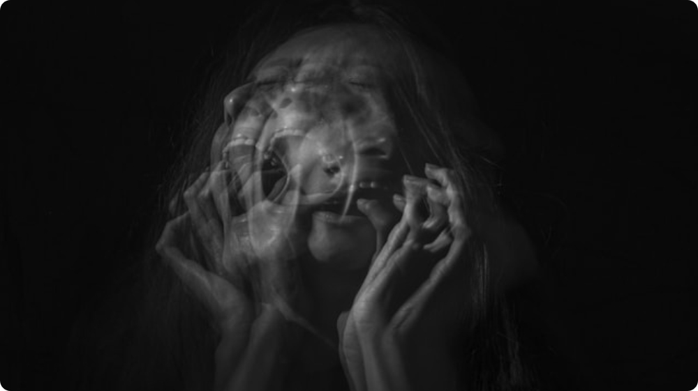 abstract image showing fragmented faces representing dissociative disorder and identity confusion