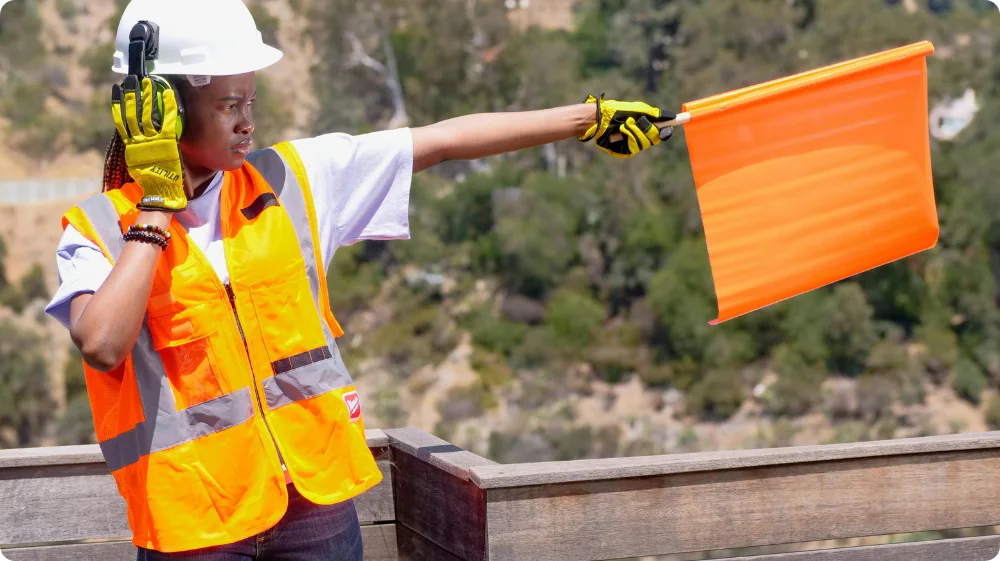 Construction site worker with all the necessary safety equipment required at a construction site while working, maintaining the health and safety standards that businesses should follow. 