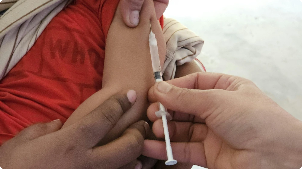 Child receiving MMR vaccine for mumps prevention