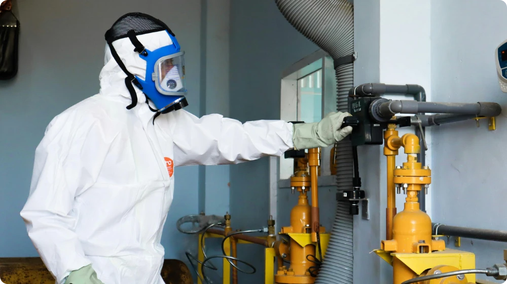 Worker wearing PPE in a UK workplace, representing COSHH compliance and safe handling of hazardous substances